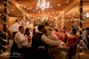 bride and groom kiss at barn wedding