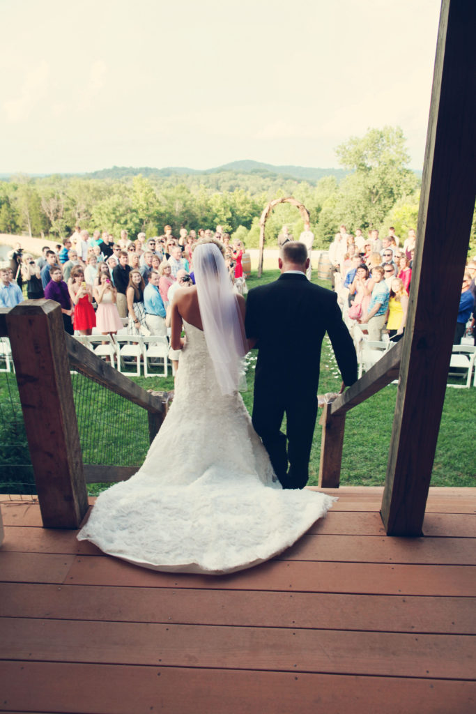 walk down the aisle rustic barn wedding