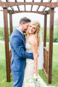 bride and groom under arbor rustic missouri wedding